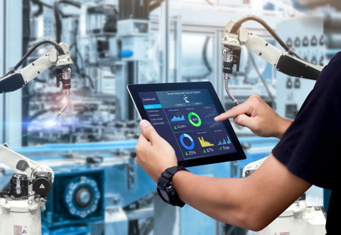 A man using a tablet to control production process in shop floor in Cloud using Closed Loop Control System